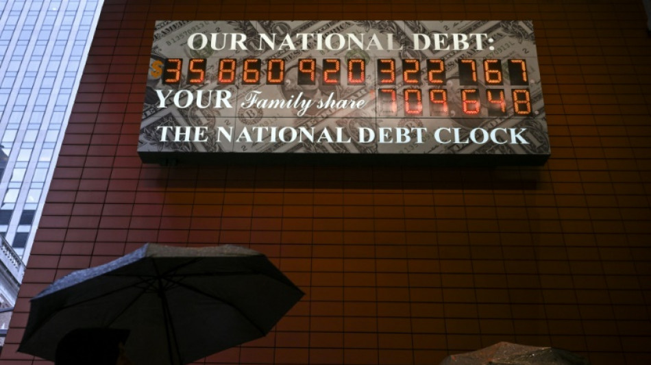 Stocks firm, dollar drops at end of rocky week