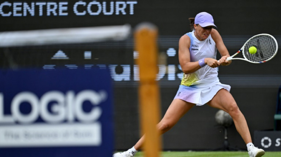 Swiatek sweeps past Paolini into first grass-court final in Germany